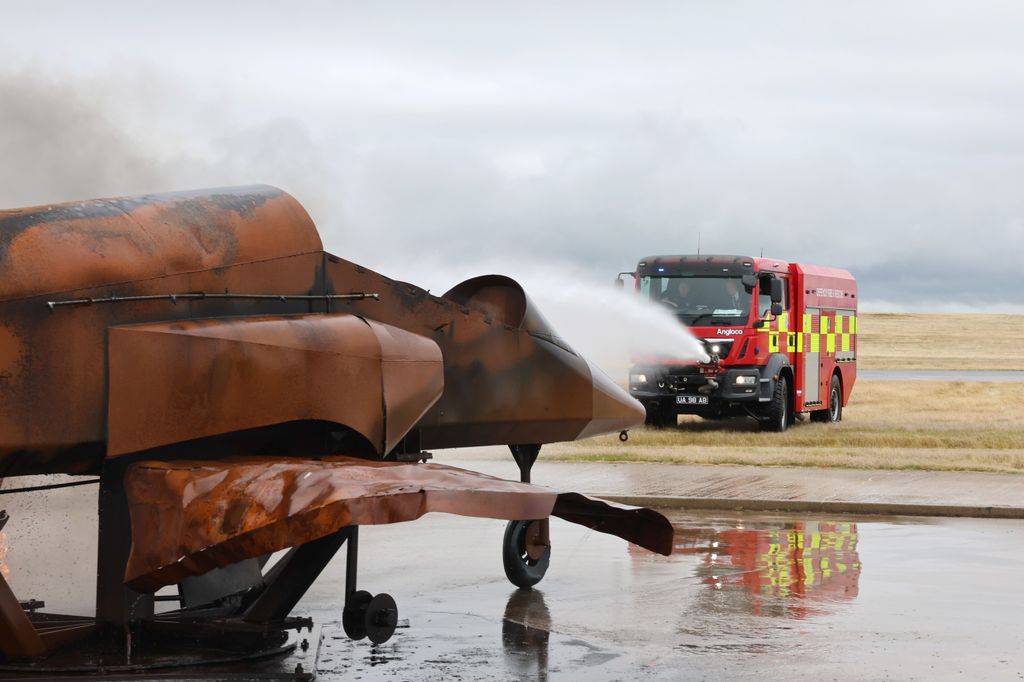 Prince William takes part in a simulated fire response exercise during an official visit at RAF Valley