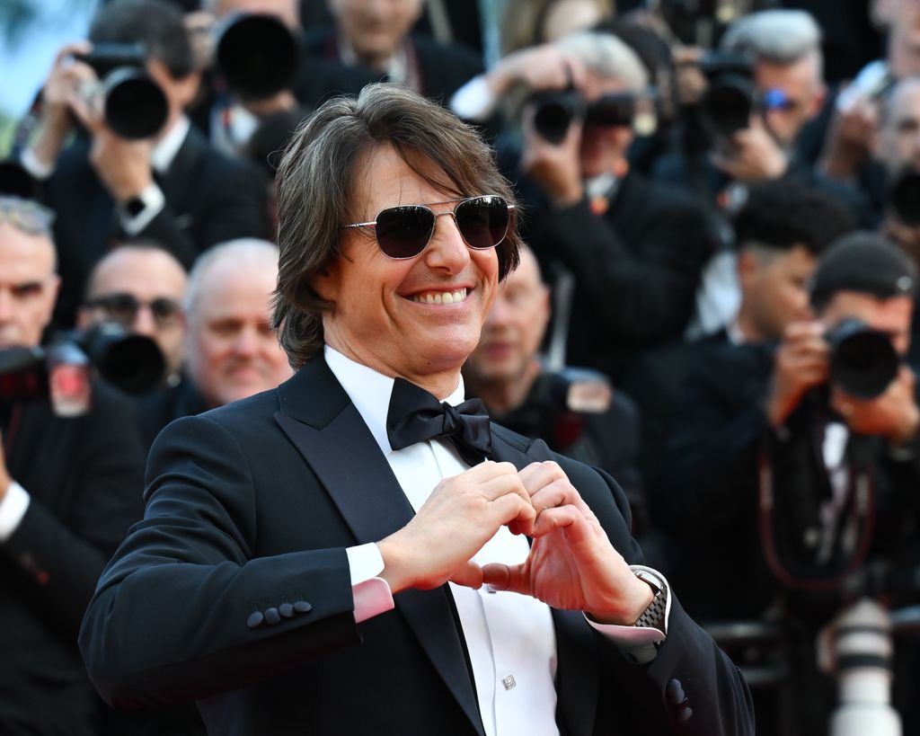 Tom Cruise making a heart shape with his hands