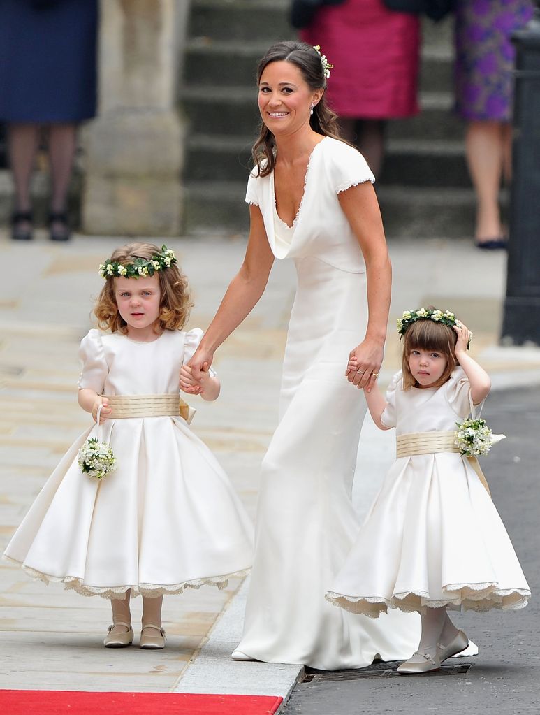 Pippa Middleton holds hands with Grace Van Cutsem and Eliza Lopes in bridesmaids dress