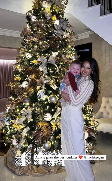 michelle keegan with baby in front of tree