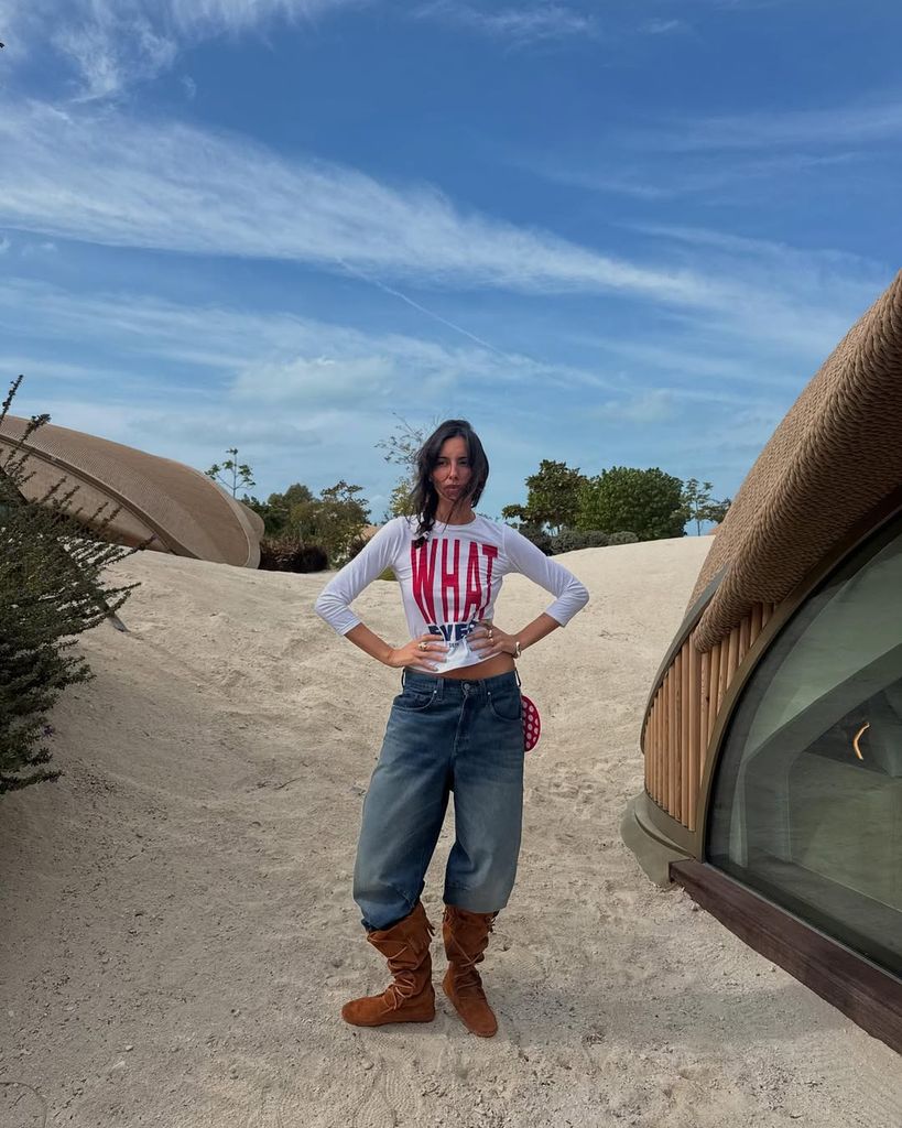 Olivia Pezzente in suede boots, jeans and white top