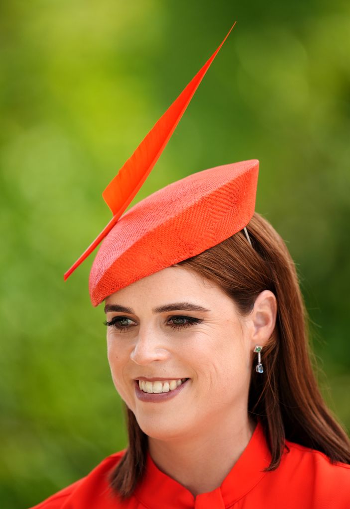 Princess Eugenie smiling neck up in red hat