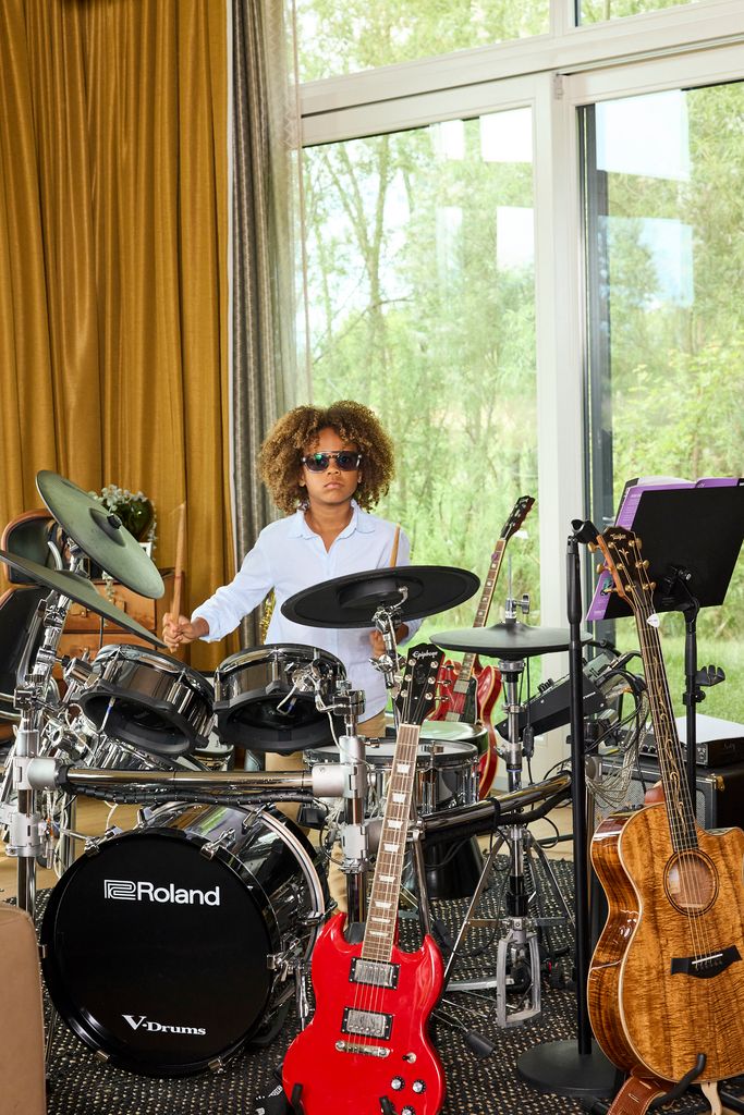 Young boy playing on a drum kit 