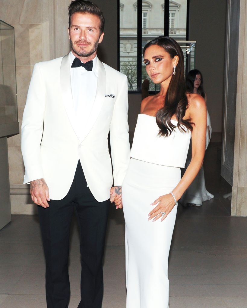 David Beckham and Victoria Beckham in matching white outfits
