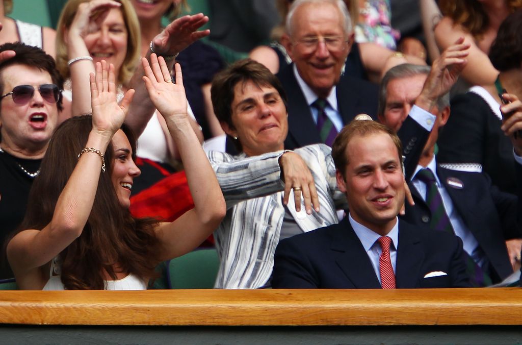 Kate Middleton joins a crowd wave at Wimbledon 2011