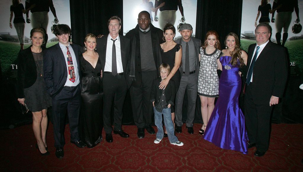 Actress Kim Dickens, Sean Tuohy Jr., Leigh Anne Tuohy, director John Lee Hancock, actor Quinton Aaron, actor Jae Head, actress Sandra Bullock, actor/musician Tim McGraw, actress Lily Collins, Collins Tuohy and Sean Tuohy  attend "The Blind Side" premiere at the Ziegfeld Theatre on November 17, 2009 in New York City
