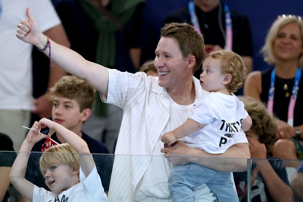 Dustin Lance Black, husband of Thomas Daley, and their children are seen in attendance as they show their support during the Men's Synchronised 10m Platform Final 