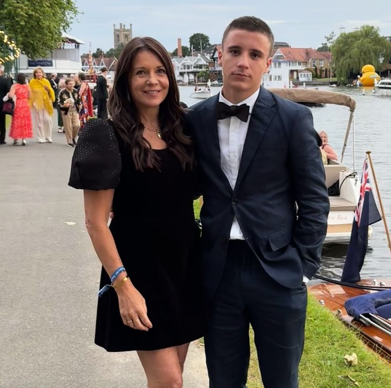 Ginny Buckley in a black dress with her son in a blaxk tuxedo