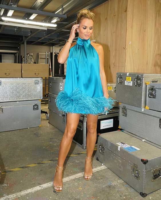 Amanda Holden posing in her blue dress 