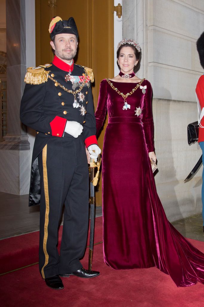Crown Princess Mary of Denmark in burgundy dress standing with frederik