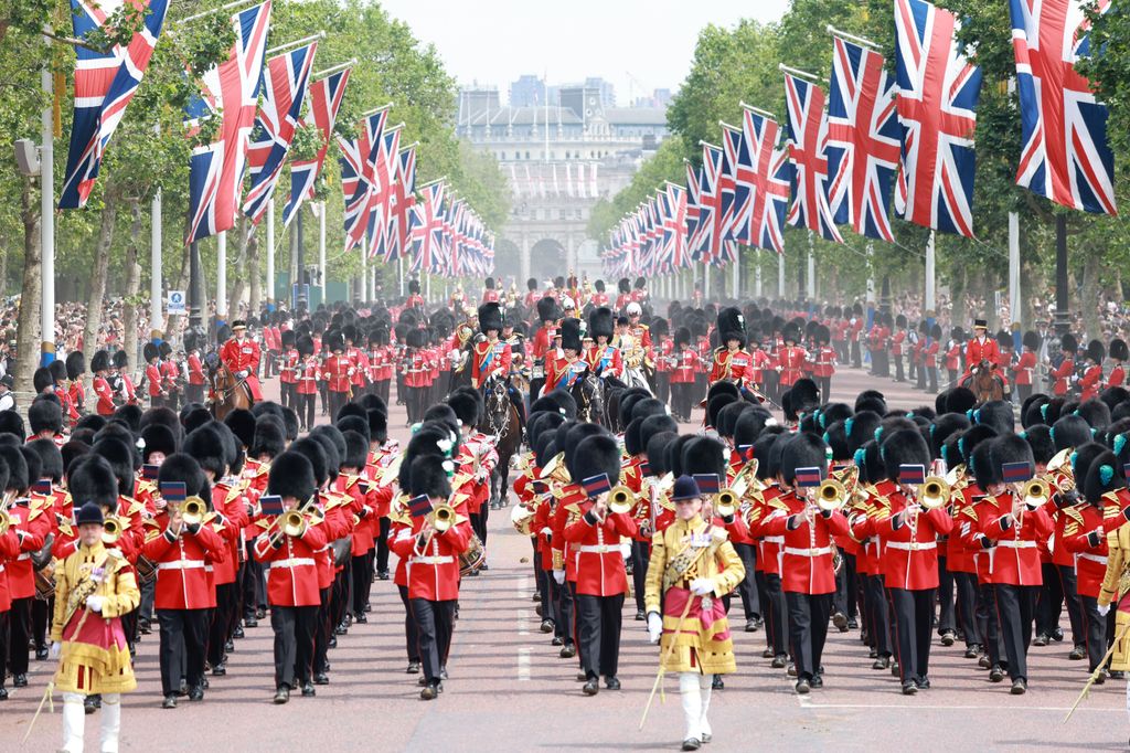 The King (centre) on horseback surrounding by soliders and flags 