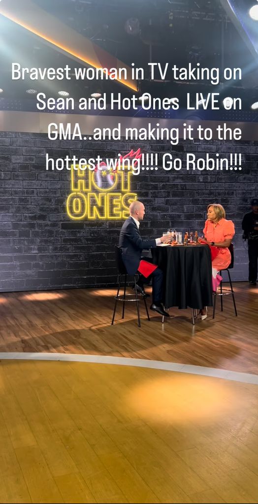 Lara Spencer cheers on GMA co-host Robin Roberts during the Hot Ones challenge in the studio, shared on Instagram