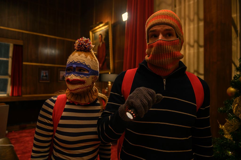 Nick and Sophia wearing ski masks as they rob Sterling's department store