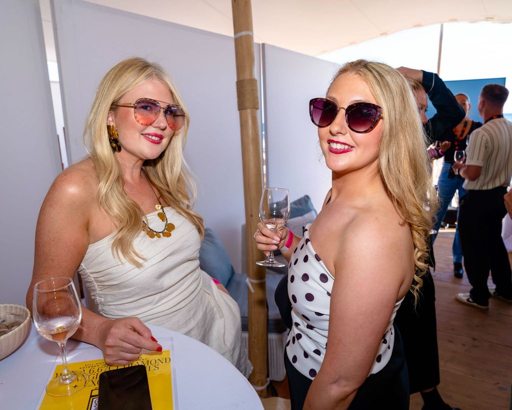 A photo of two blonde women wearing sunglasses