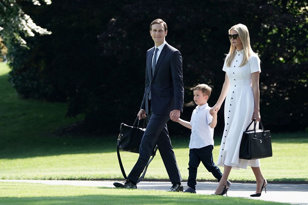  Ivanka Trump wearing a white dress as she walks with her husband Jared Kushner and their son Joseph Kushner on the South Lawn of the White House 