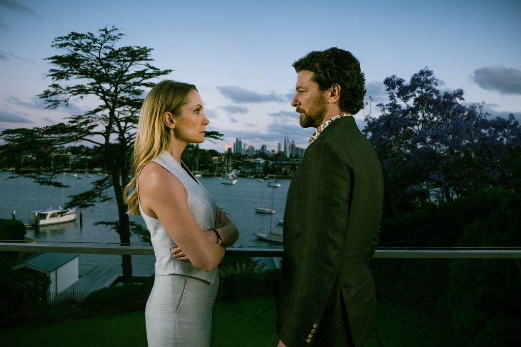 A woman and man looking at each other on balcony