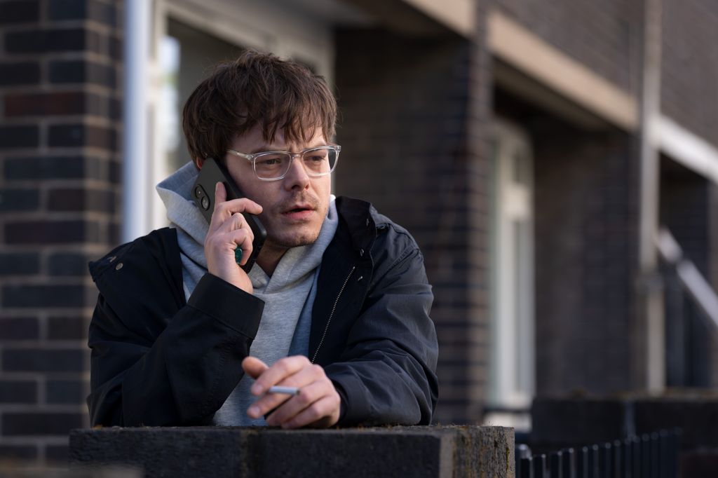 man on phone smoking cigarette