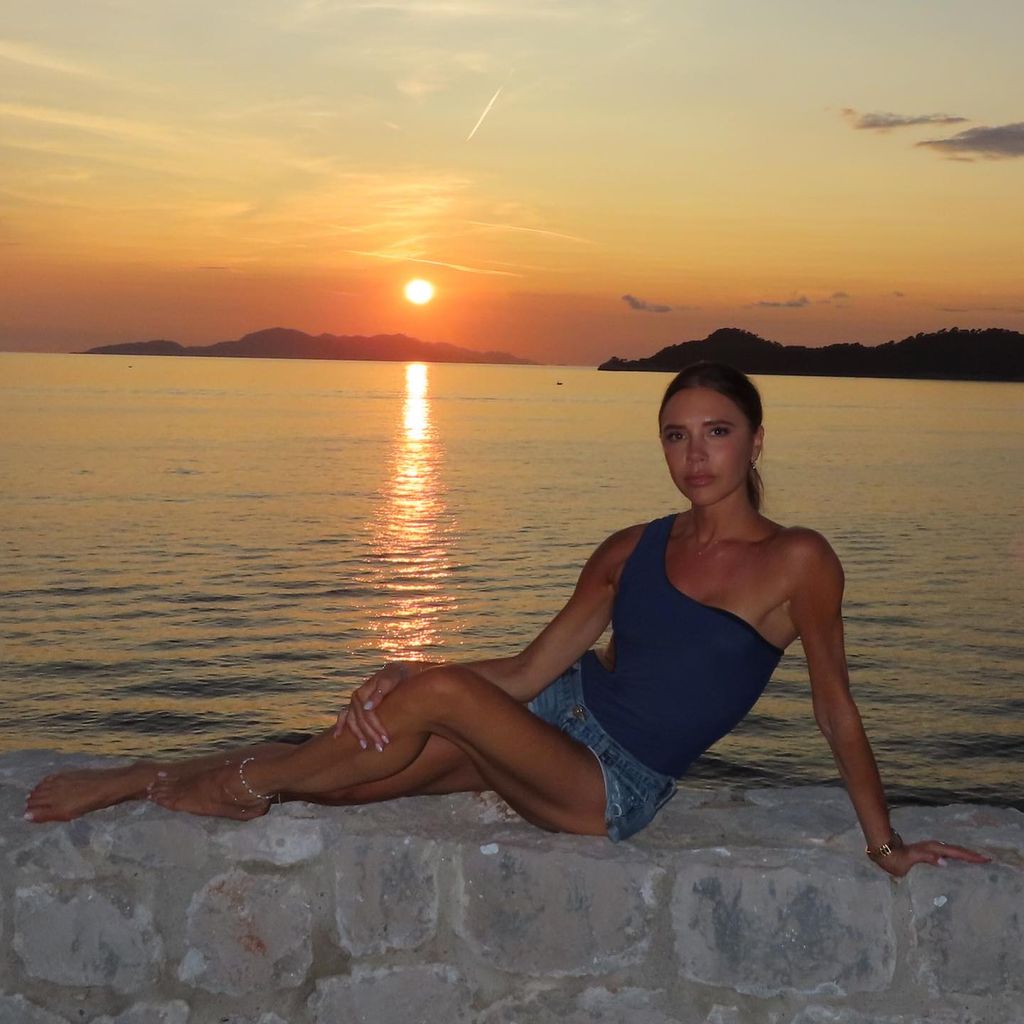 Victoria Beckham posing on a wall in Croatia