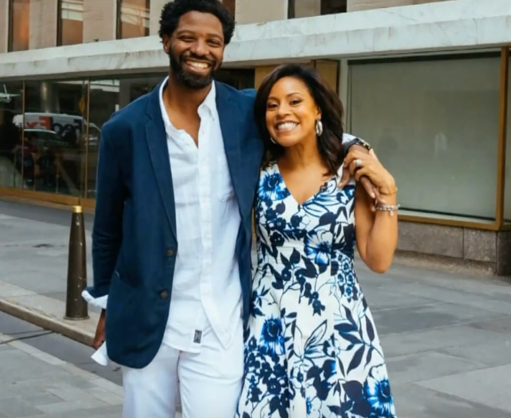 Sheinelle in white and blue floral dress standing with husband Uche