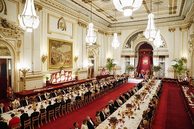 State Banquet guests sit at long tables in buckingham palace