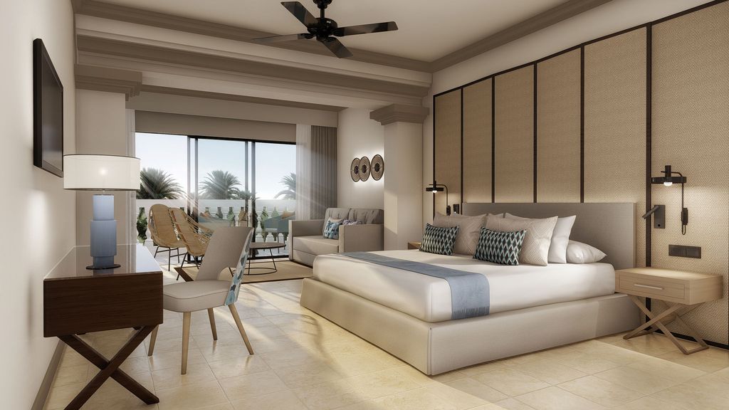 bedroom suite with bed, night stand and lounge area