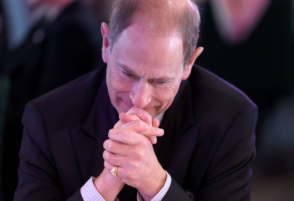 Prince Edward with his hands underneath his head