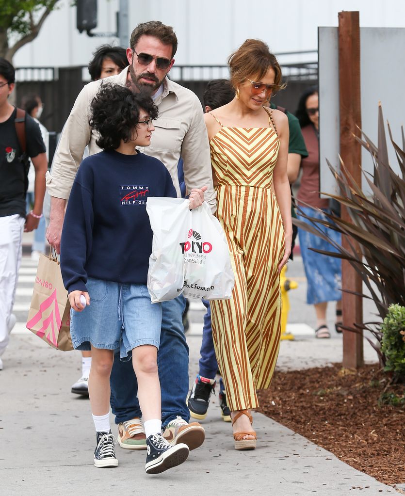 Ben Affleck and Jennifer Lopez take a walk round the neighbourhood with daughter Emmy