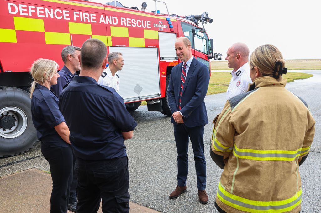 Prince William talks to base personnel after a simulated fire response exercise during an official visit at RAF Valley