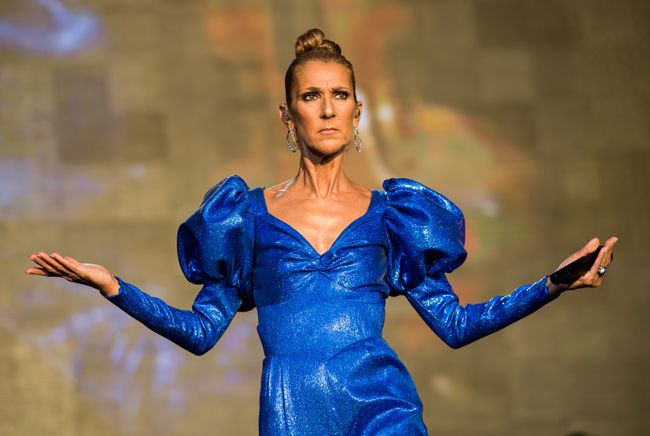 celine dion wearing a statement blue dress on stage