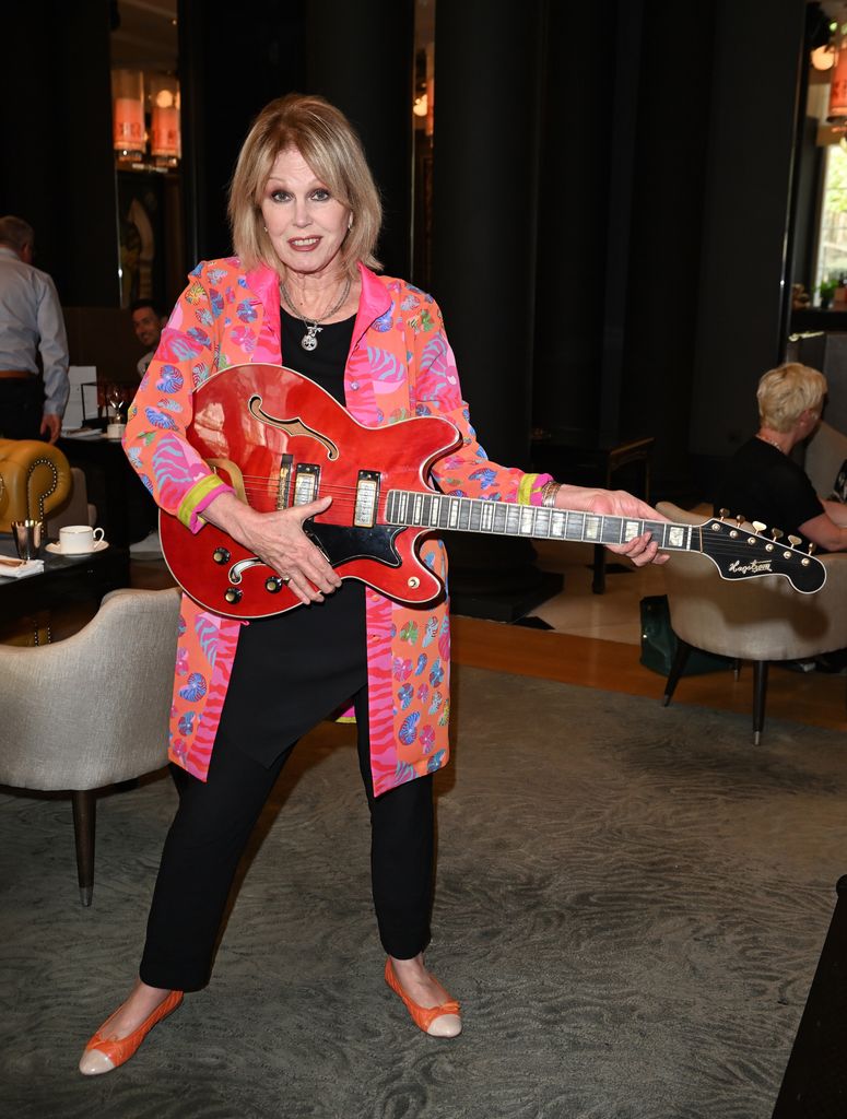 Joanna Lumley wears colourful jacket as she plays guitar
