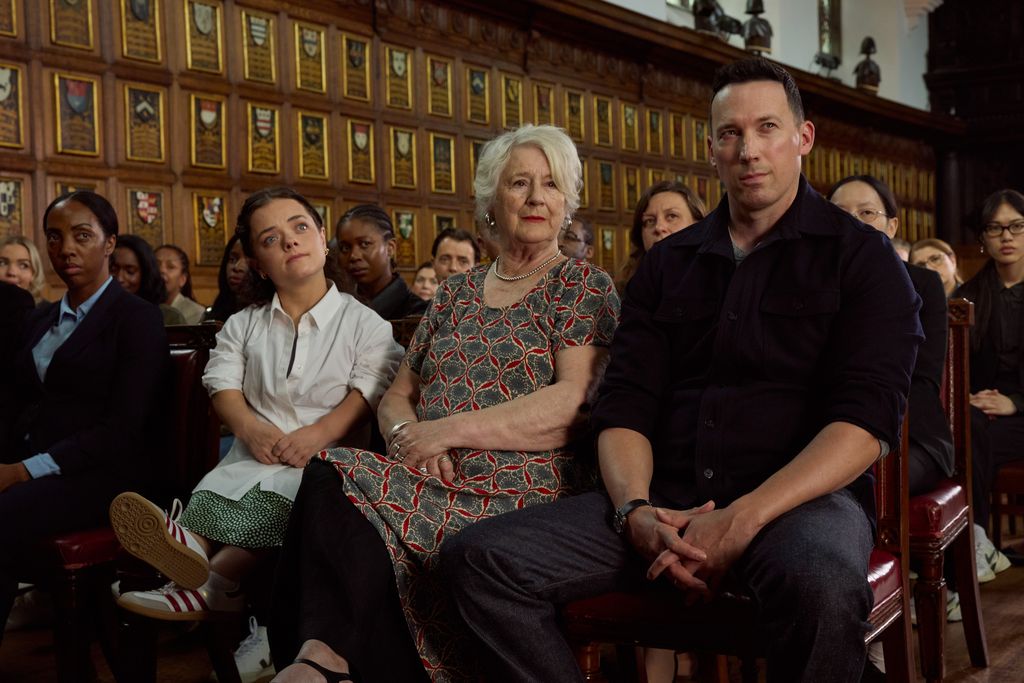 Brunette woman in white, lady with white hair and man dressed in dark clothing sitting in a church 