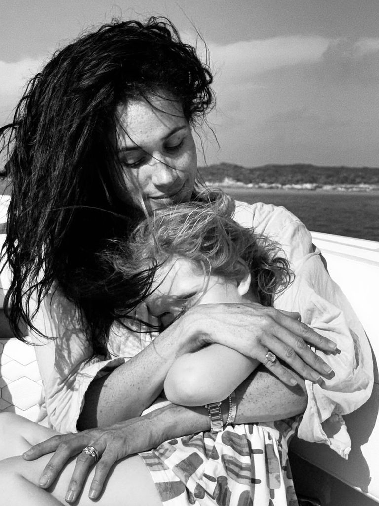 Meghan Markle cuddling Lilibet on a boat 