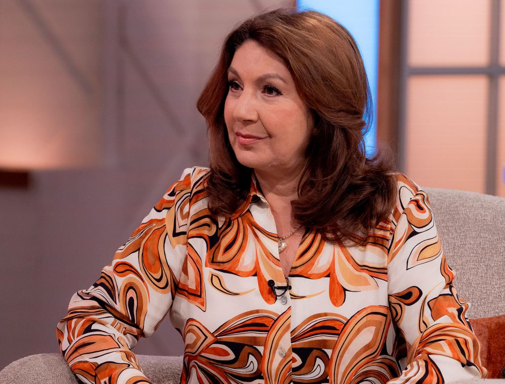 Jane McDonald in a white and orange outfit