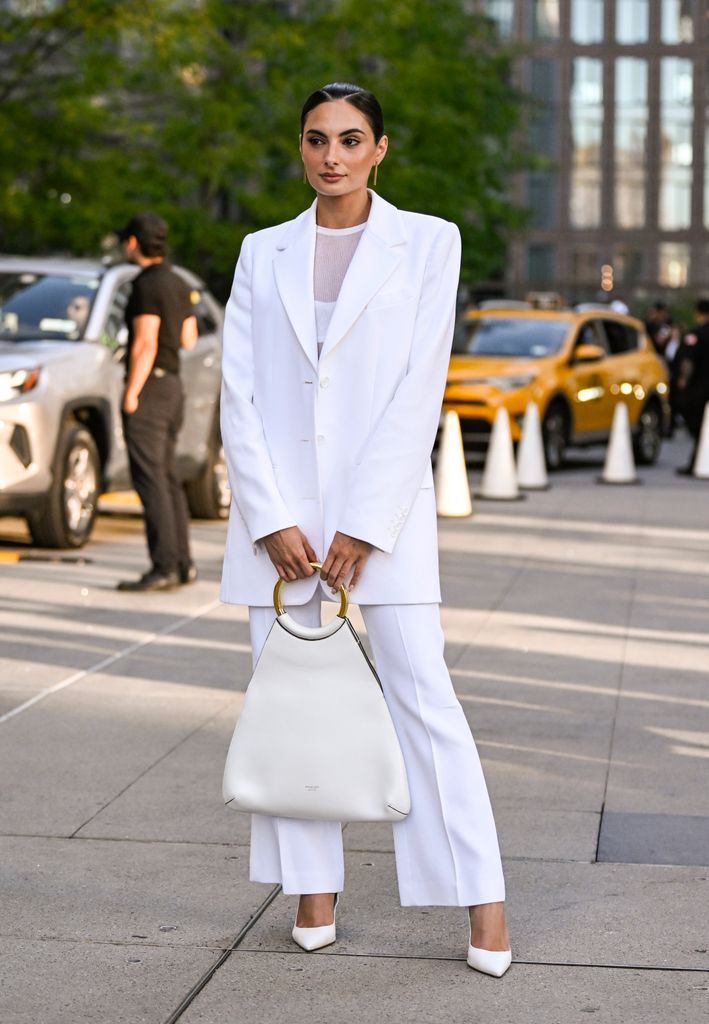 Paige DeSorbo is seen wearing a white Michael Kors jacket, sheer top and pants outside the Michael Kors show during NYFW Spring/Summer 2025 on September 10, 2024 in New York City