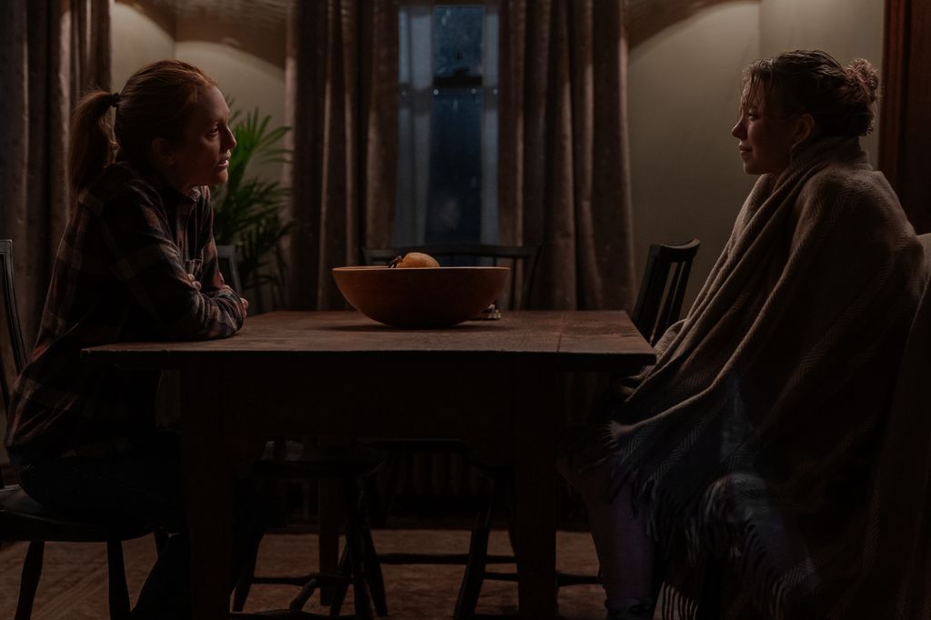 two women sitting opposite each other at kitchen table