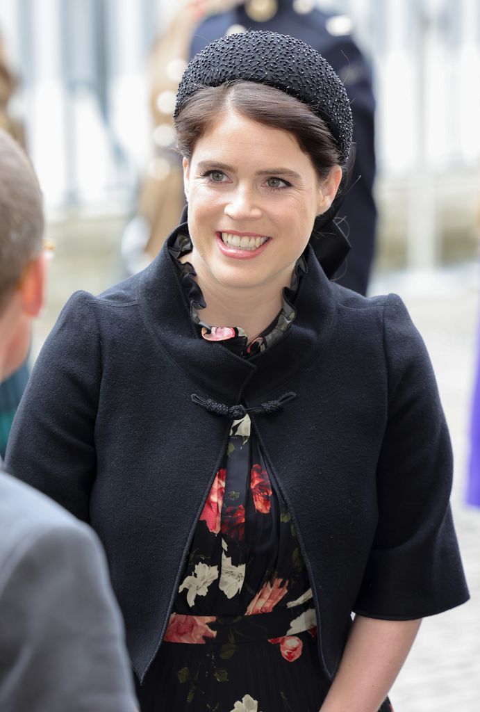 Princess Eugenie smiling while in a black outfit