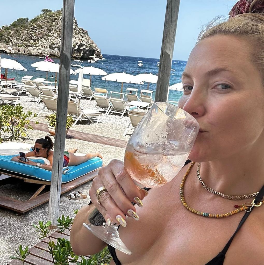 Kate Hudson sipping wine on the beach