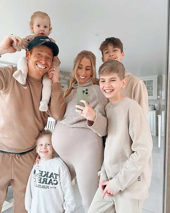 Stacey posing for a mirror selfie alongside her family