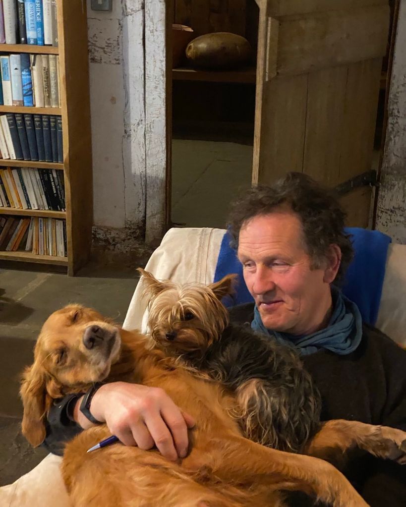 monty don stroking two pet dogs 