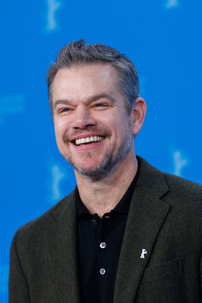 Matt Damon smiling in a suit