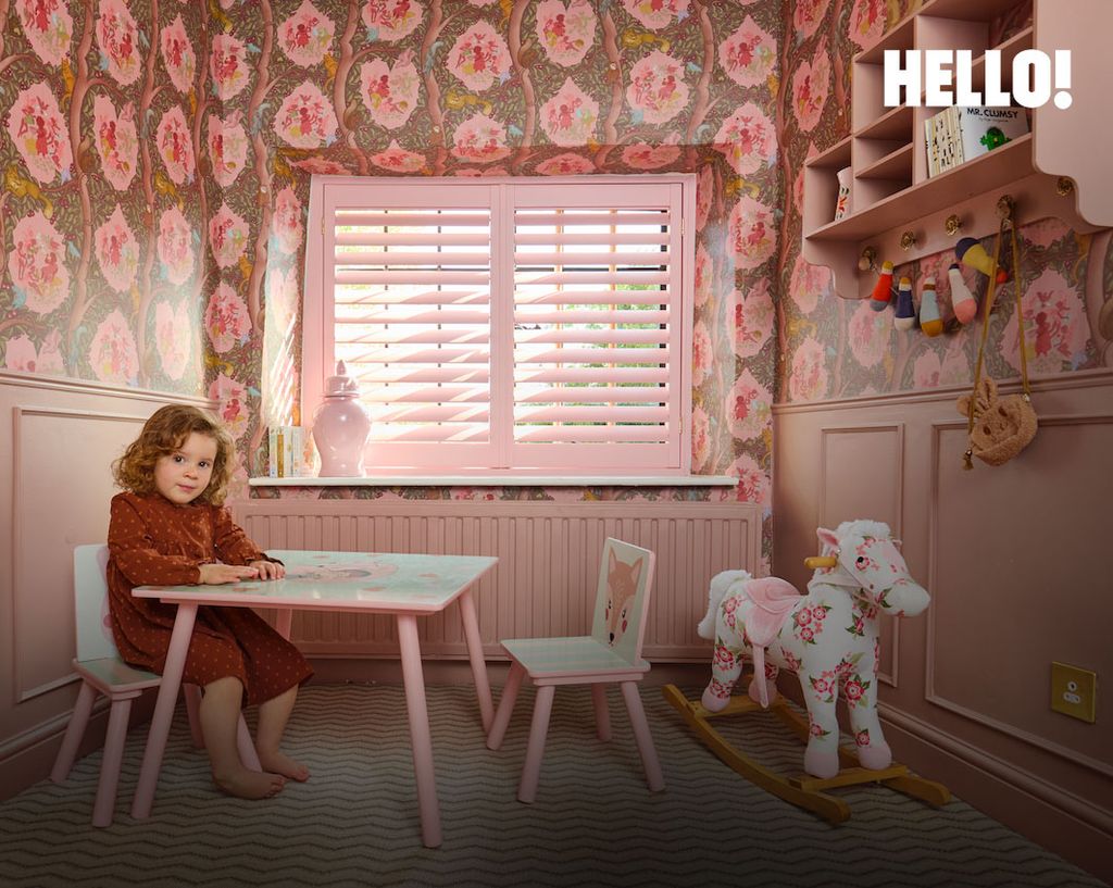young girl on chair in pink bedroom