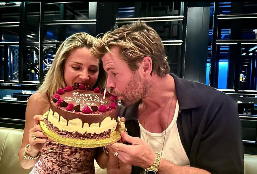 Photo posted by Chris Hemsworth on Instagram in honor of his wife Elsa Pataky's 47th birthday on July 18, where they are pictured both eating a birthday cake