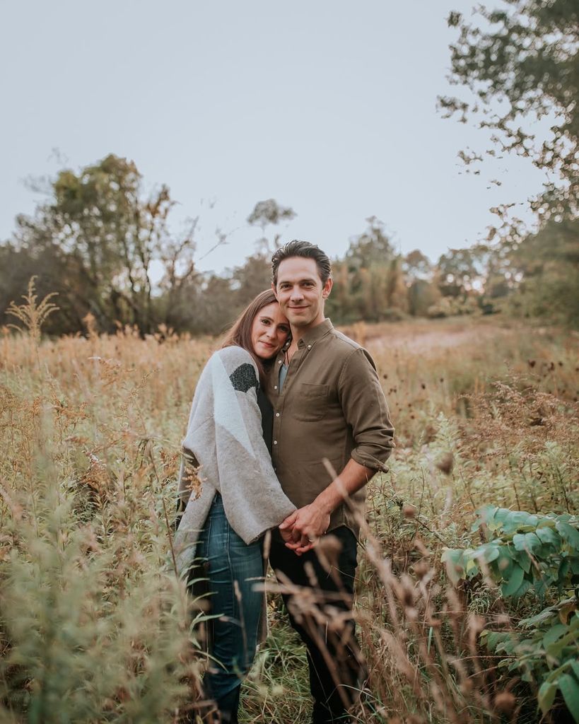 Michael Rady and wife Rachael Kemery pose in a field