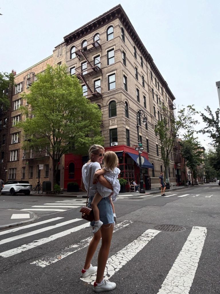 Kitty with her daughter outside new york apartment block