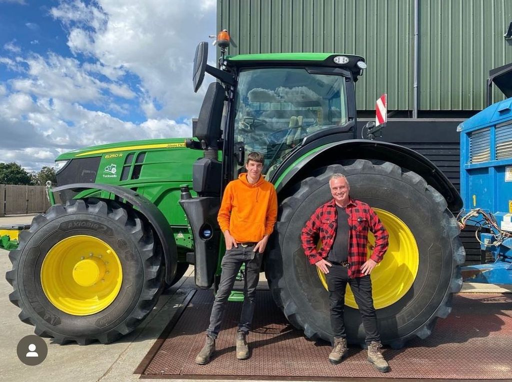 Reuben Owen and Dave Nicholson standing in front of a tractor