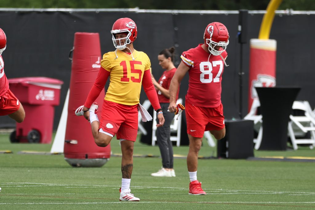 Kansas City Chiefs quarterback Patrick Mahomes (15) and Kansas City Chiefs tight end Travis Kelce (87) stretch during OTA's on June 18, 2025