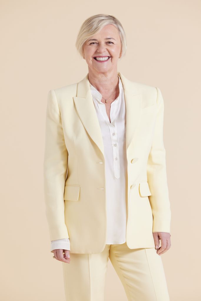Woman in pastel yellow suit smiling