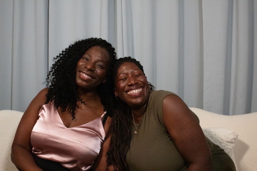 Ateh Jewel and Tanya Moodie smiling and cuddling in HELLO!'s podcast studio
