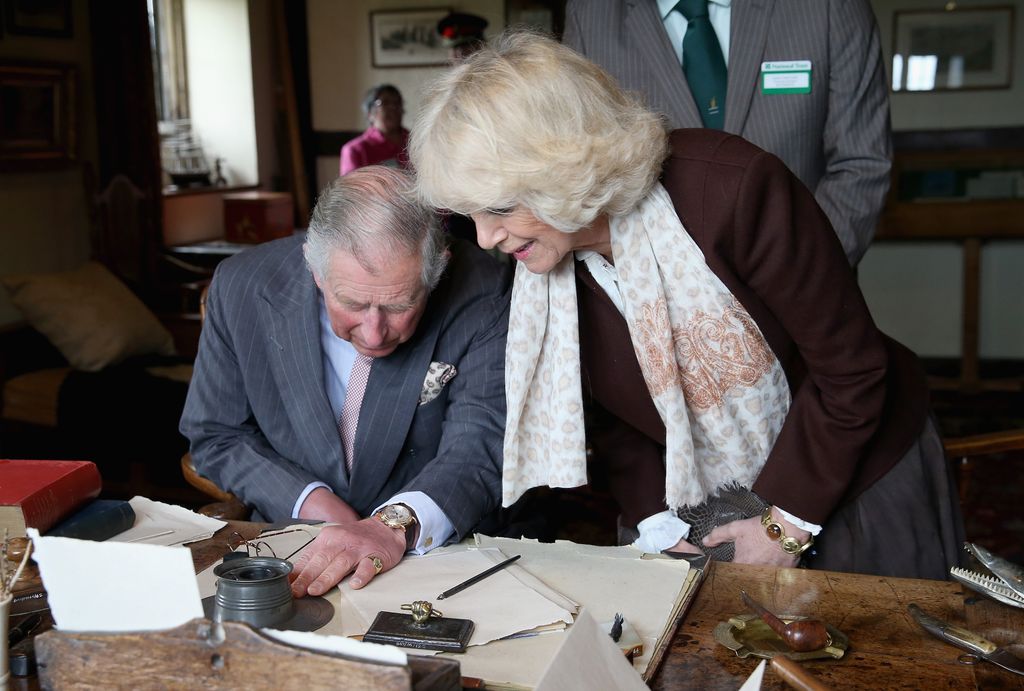 King Charles and Queen Camilla working hard at a desk