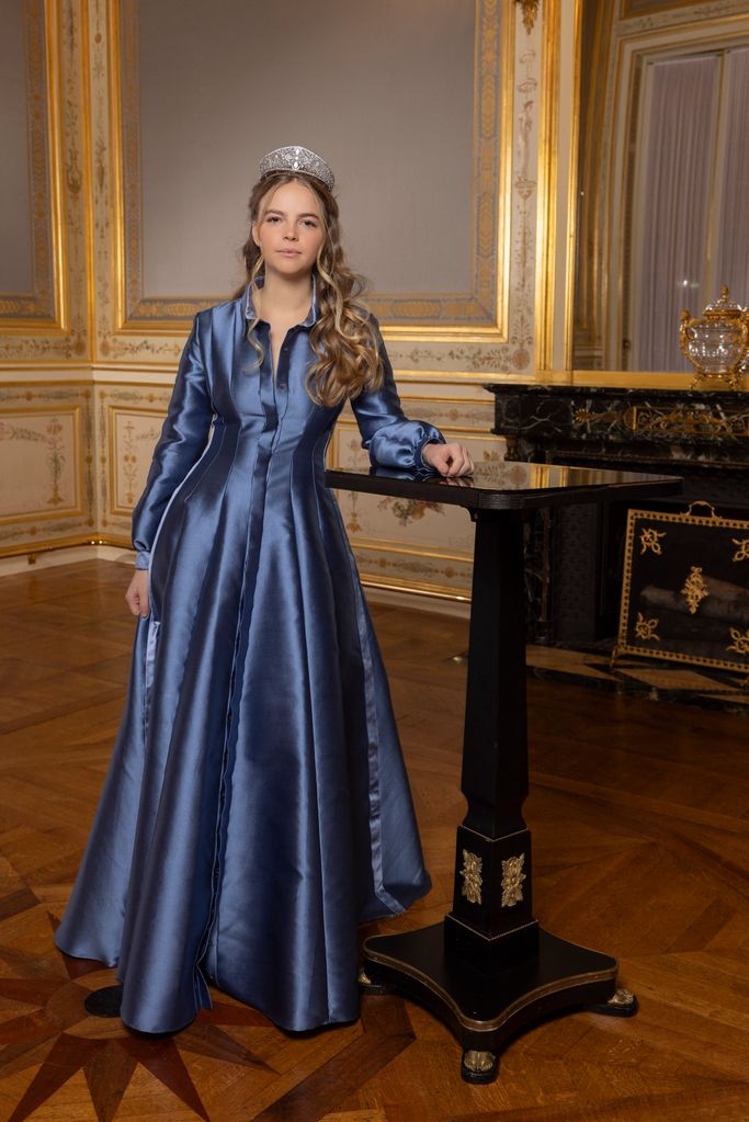 Princess wears a satin blue gown and diamond tiara
